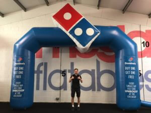 Giant inflatable domino's arch with logo on top