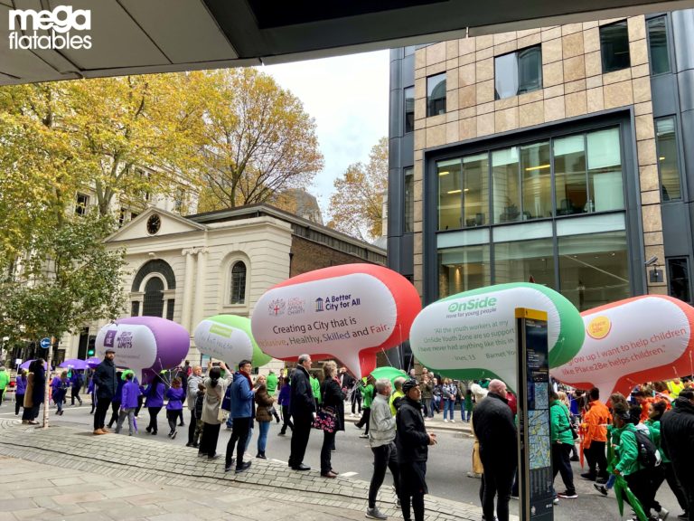 people walking with inflatable speech bubbles